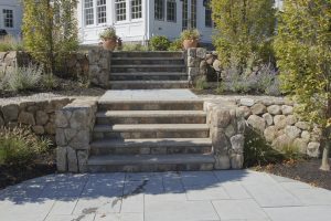 Natural stone risers and retaining wall