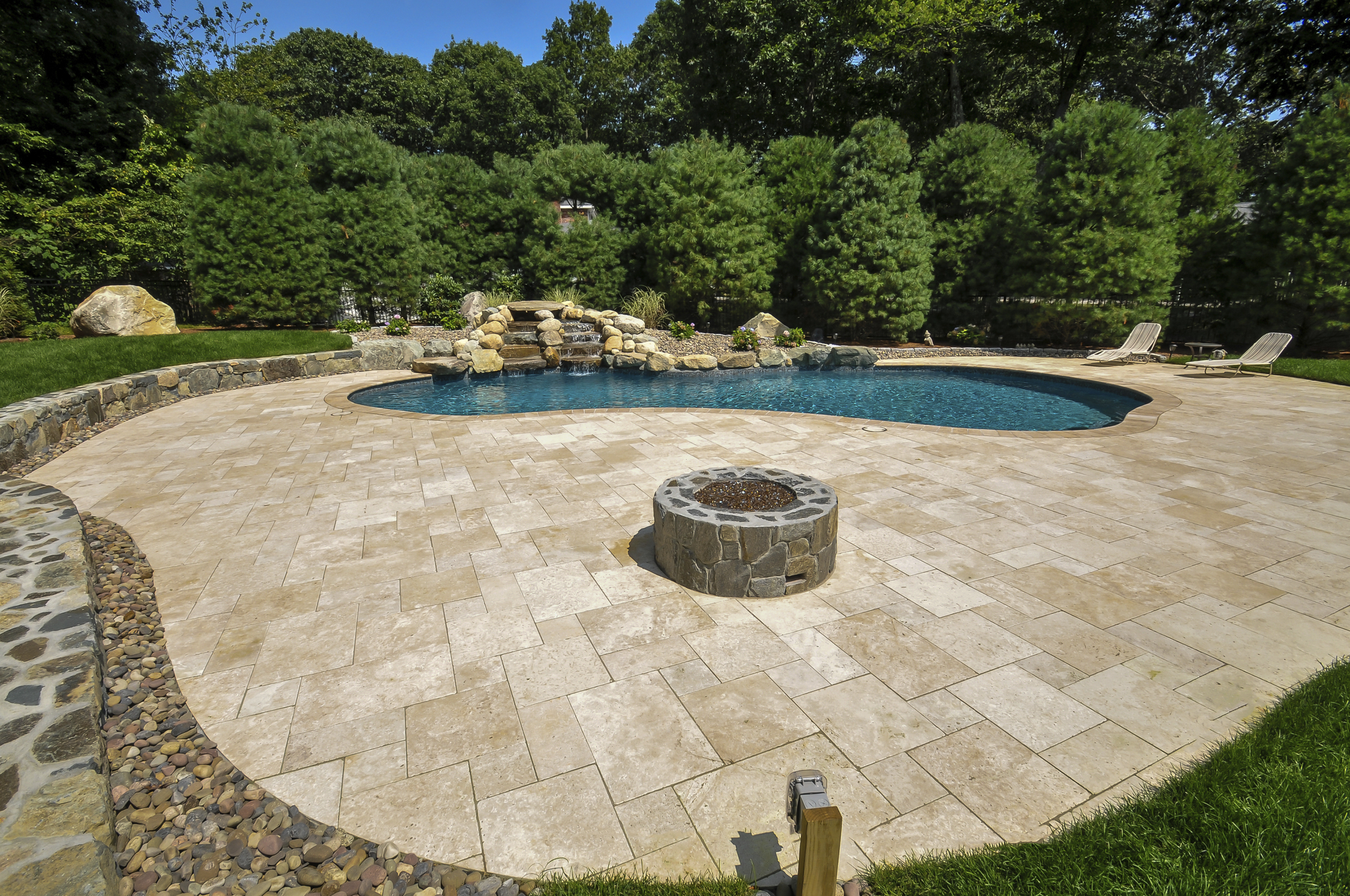 Natural stone pool patio with fire pit