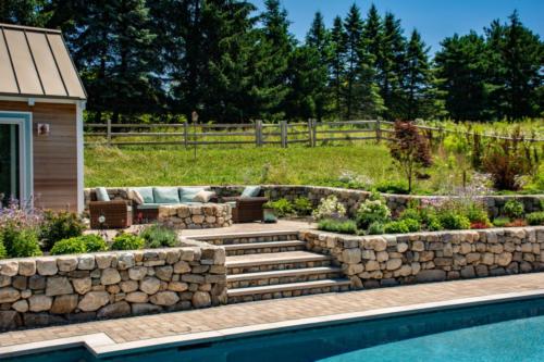 Natural Stone retaining wall around pool area with steps