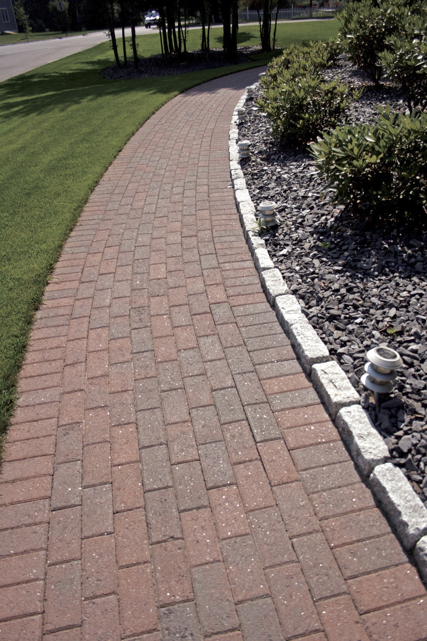 Pave Edge Rigid Work starts by laying the edging along the prepared perimeter, directly ...