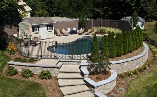 Exposed Aggregate Pool Patio with Retaining Wall and Cabana
