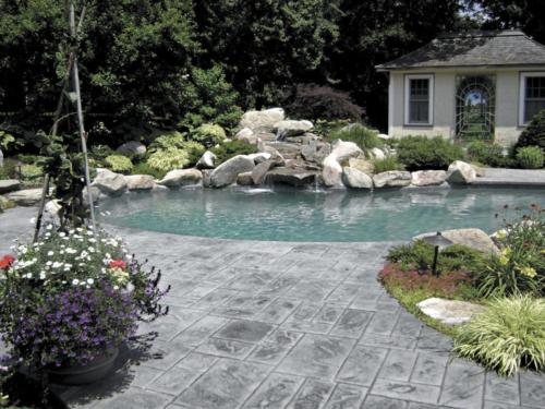 Stamped Concrete Pool Patio with Natural Stone Water Feature