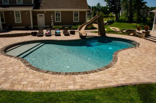 Pool patio with pavers and slide